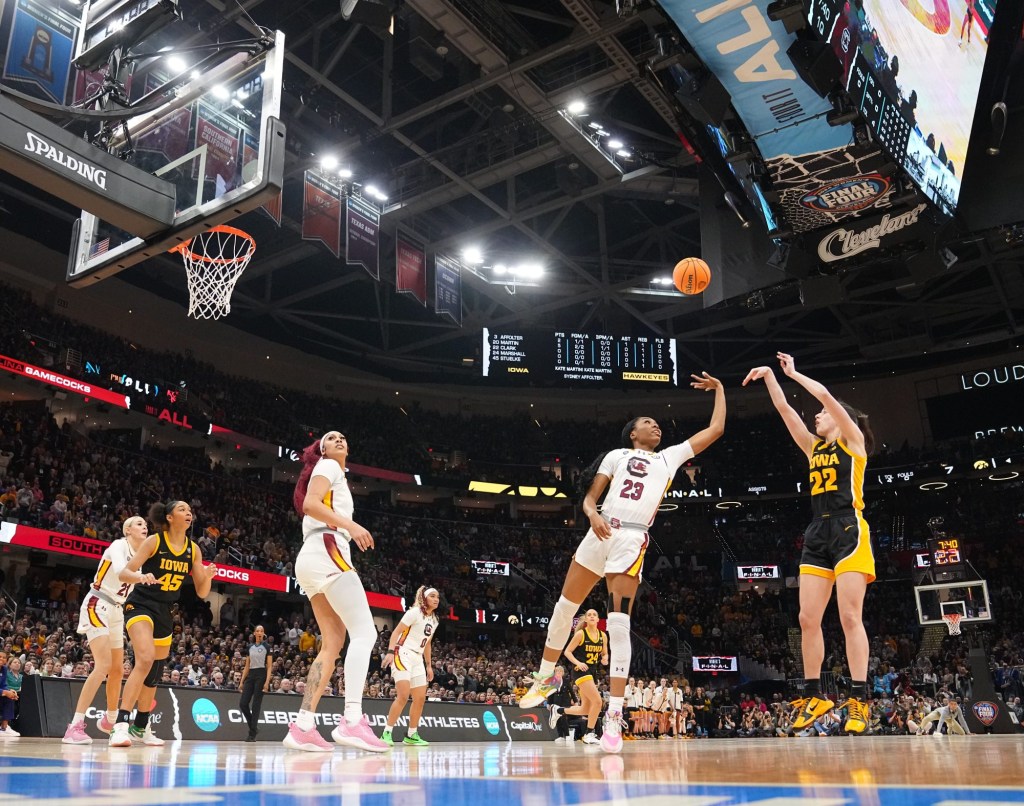 Iowa Hawkeyes guard Caitlin Clark (22) shoots the ball as South Carolina Gamecocks guard Bree Hall (23) defends during the NCAA Tournament championship basketball game at Rocket Mortgage Fieldhouse, Sunday, April 7, 2024 in Cleveland.