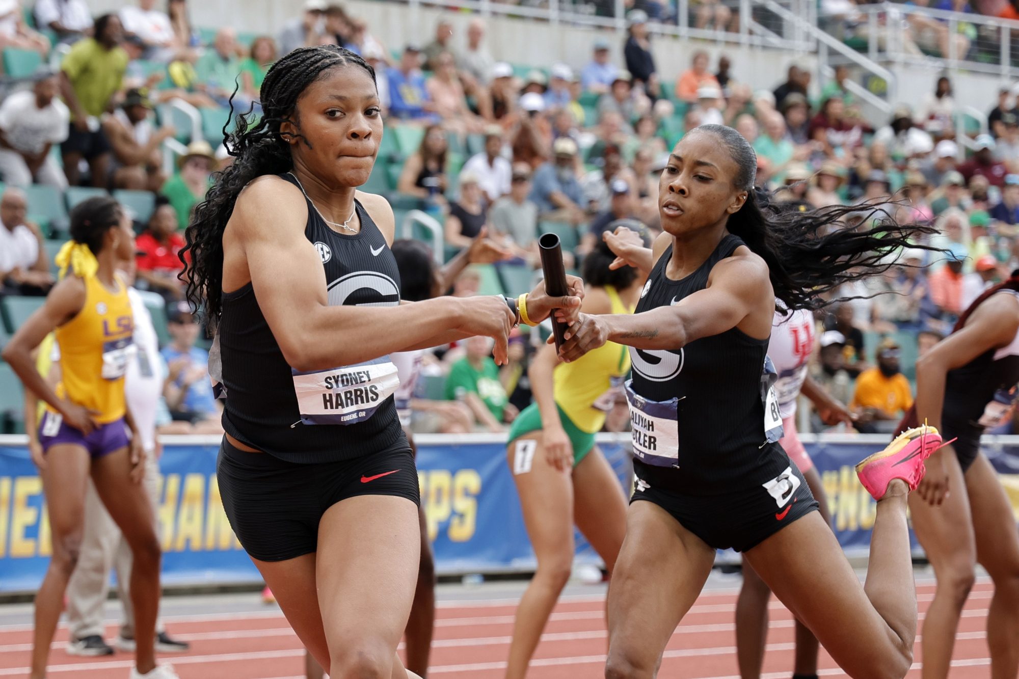 Jun 8, 2024; Eugene, OR, USA; Sydney Harris takes the handoff from Aaliyah Butler on the third leg of the Georgia women's 4 x 400m relay that placed fourth in a school record 3:24.26 during the NCAA Track and Field Championships at Hayward Field.