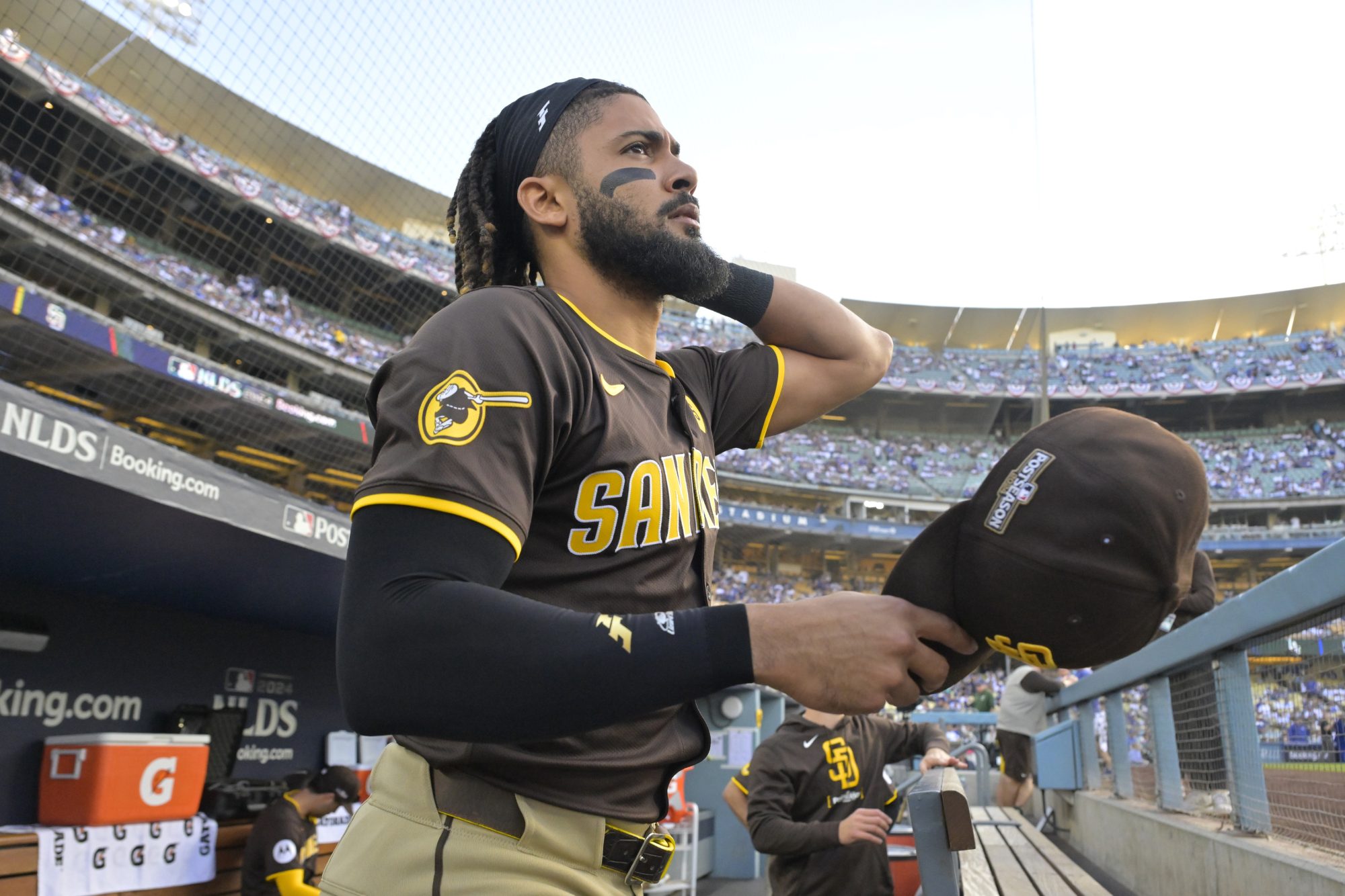 Oct 11, 2024; Los Angeles, California, USA; San Diego Padres outfielder Fernando Tatis Jr. (23) looks on from the dugout before game five against the Los Angeles Dodgers in the NLDS for the 2024 MLB Playoffs at Dodger Stadium.