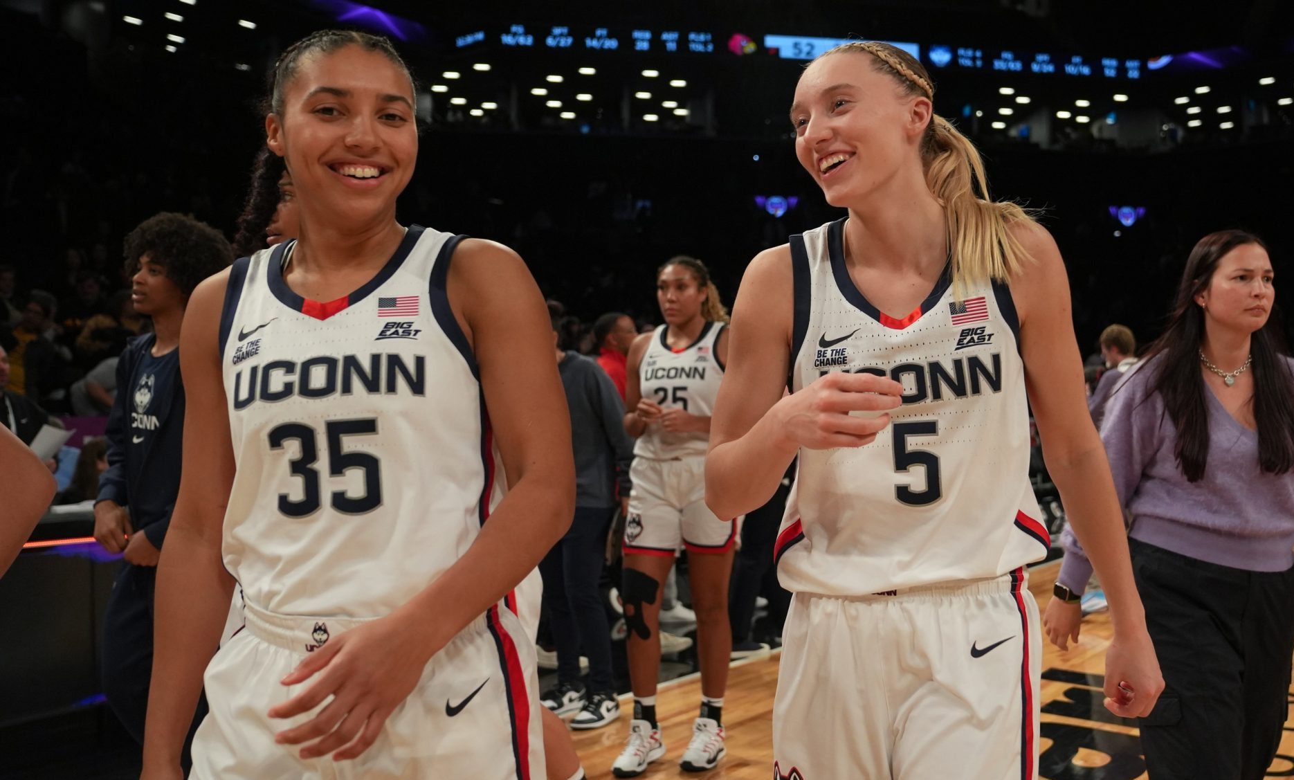 Dec 7, 2024; Brooklyn, New York, USA; Connecticut Huskies guard Azzi Fudd (35) and Connecticut Huskies guard Paige Bueckers (5) celebrate after the game against the Louisville Cardinals at Barclays Center.