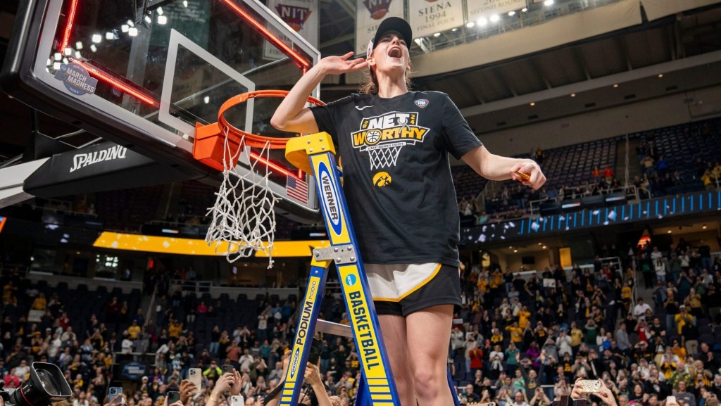 Iowa Hawkeyes guard Caitlin Clark (22) cuts down the net after beating LSU in the Elite 8 round of the NCAA Women's Basketball Tournament between Iowa and LSU at MVP Arena, Monday, April 1, 2024 in Albany, N.Y.