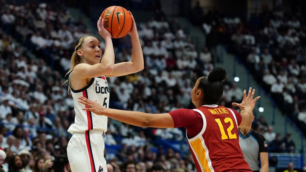 Dec 21, 2024; Hartford, Connecticut, USA; UConn Huskies guard Paige Bueckers (5) looks to pass the ball against USC Trojans guard JuJu Watkins (12) in the first half at XL Center.