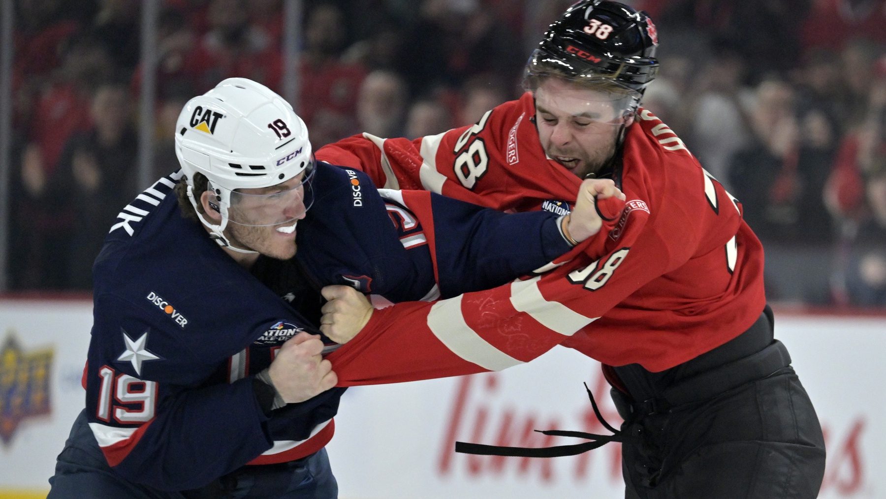 Feb 15, 2025; Montreal, Quebec, CAN; [Imagn Images direct customers only] Team United States forward Matthew Tkachuk (19) and Team Canada forward brandon Hagel (38) fight in the first period during a 4 Nations Face-Off ice hockey game at the Bell Centre.