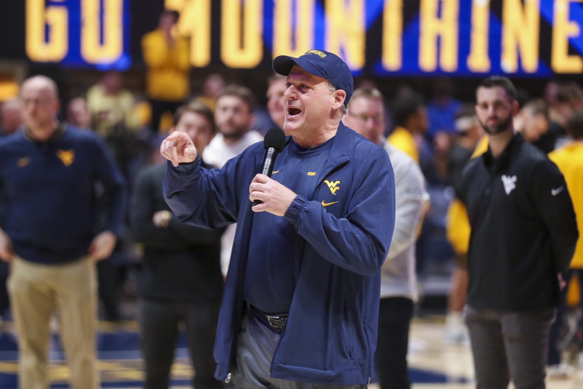 Feb 19, 2025; Morgantown, West Virginia, USA; West Virginia Mountaineers head football coach Rich Rodriguez speaks to the crowd during a timeout during the first half against the Cincinnati Bearcats at WVU Coliseum.