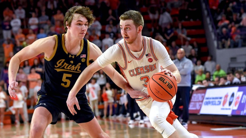 Feb 26, 2025; Clemson, South Carolina, USA; Clemson guard Jake Heidbreder (3) dribbles around Notre Dame guard Cole Certa (5) during the second half at Littlejohn Coliseum.