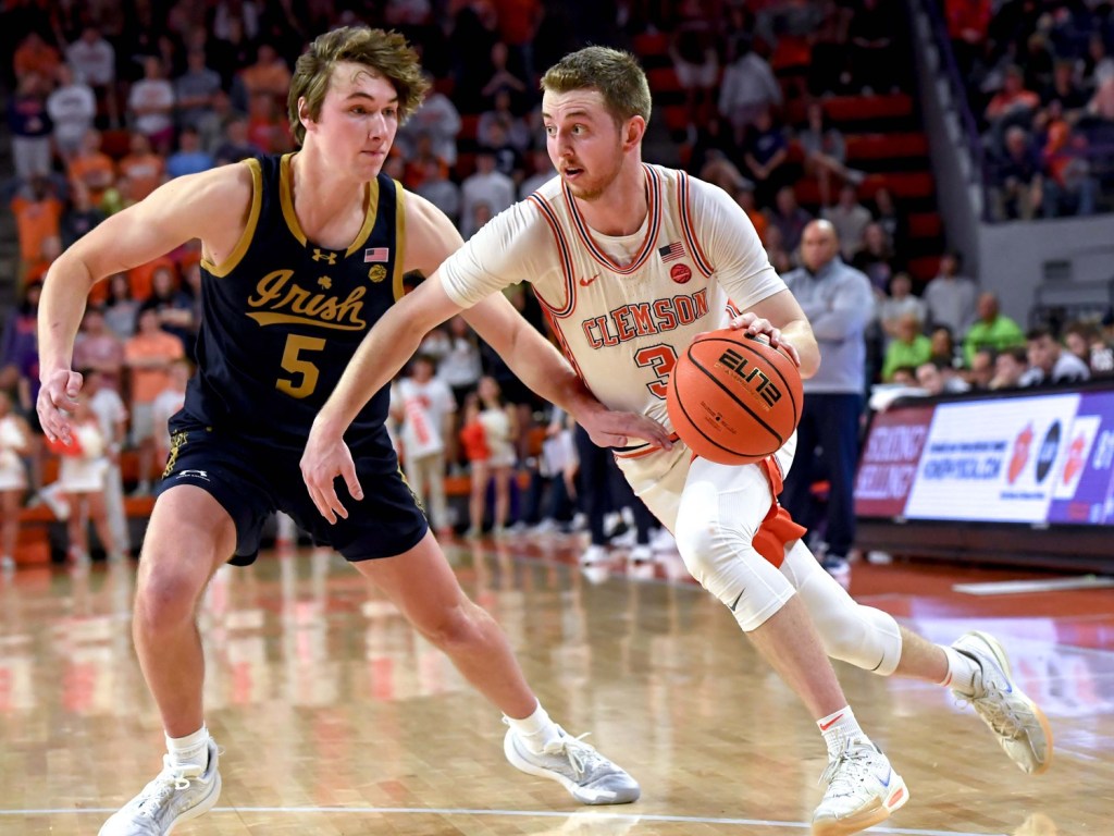 Feb 26, 2025; Clemson, South Carolina, USA; Clemson guard Jake Heidbreder (3) dribbles around Notre Dame guard Cole Certa (5) during the second half at Littlejohn Coliseum.