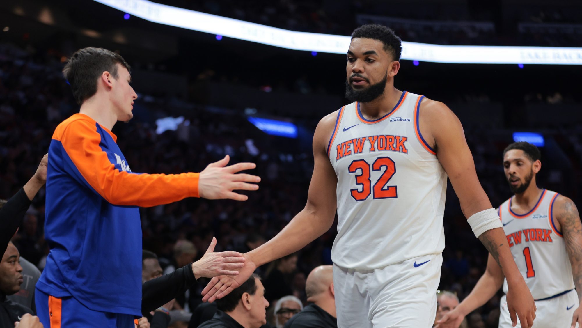 Mar 2, 2025; Miami, Florida, USA; New York Knicks center Karl-Anthony Towns (32) high-fives with teammates during the second quarter against the Miami Heat at Kaseya Center.