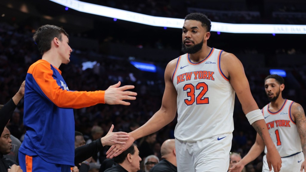 Mar 2, 2025; Miami, Florida, USA; New York Knicks center Karl-Anthony Towns (32) high-fives with teammates during the second quarter against the Miami Heat at Kaseya Center.