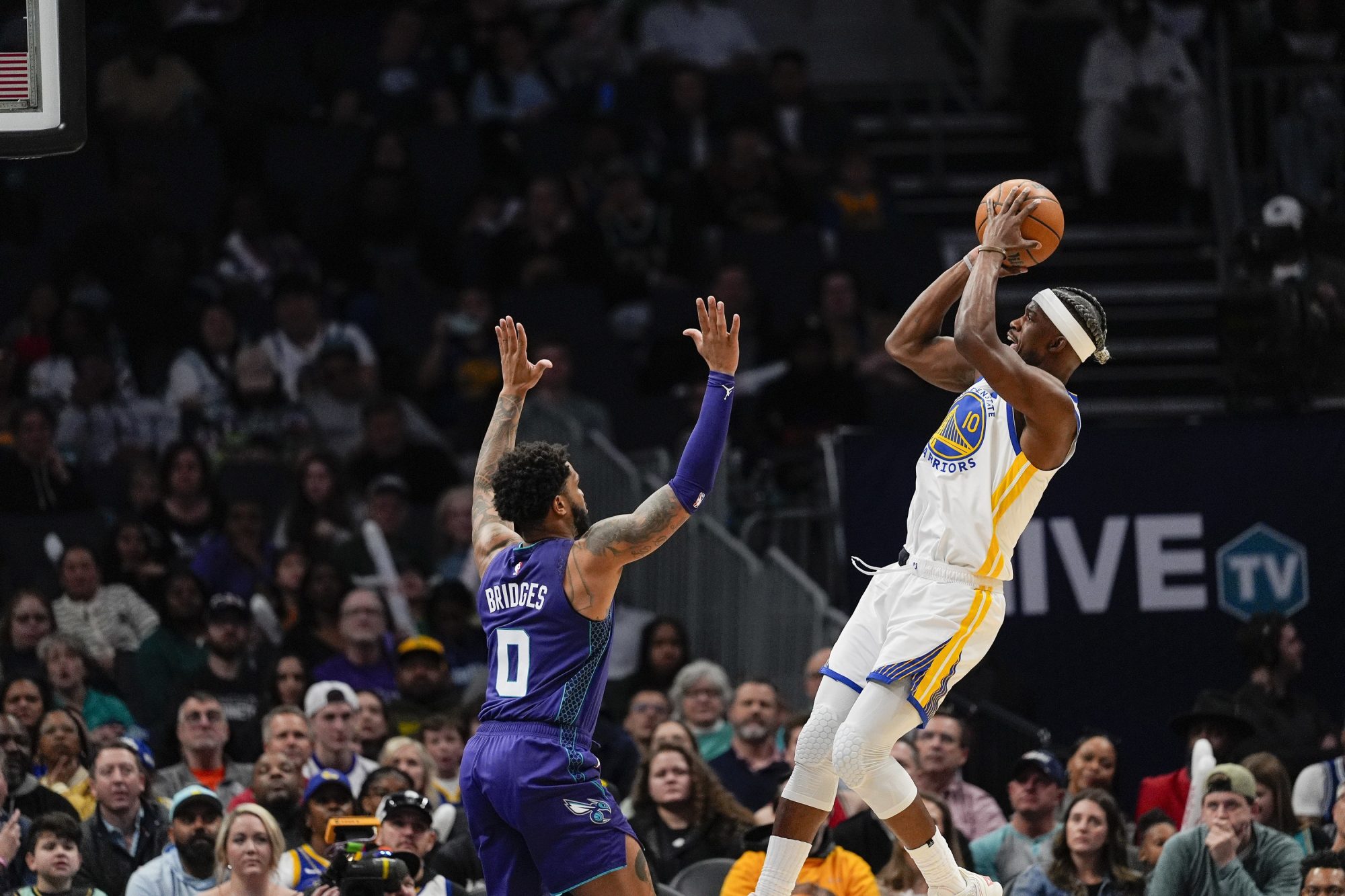 Mar 3, 2025; Charlotte, North Carolina, USA; Golden State Warriors forward Jimmy Butler III (10) drops back to shoot against Charlotte Hornets forward Miles Bridges (0) during the second half at Spectrum Center.