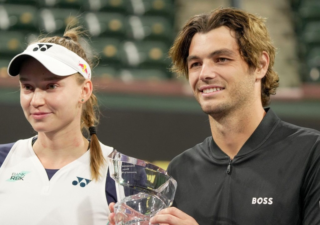 Elena Rybakina, left, and Taylor Fritz hold the trophy after winning the Eisenhower Cup Tie Break Tens during the BNP Paribas Open in Indian Wells, Calif., March 4, 2025.