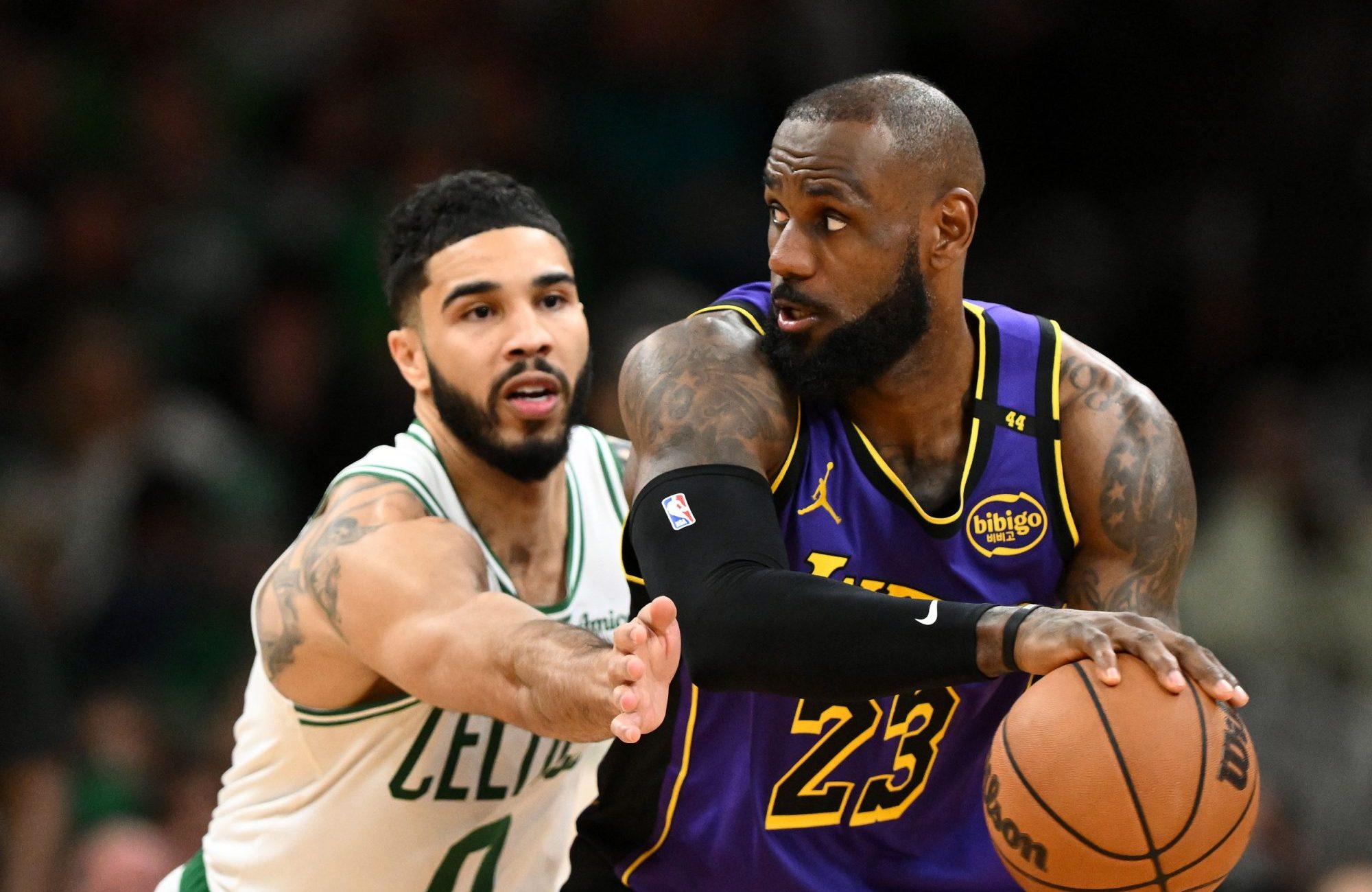 Mar 8, 2025; Boston, Massachusetts, USA; Los Angeles Lakers forward LeBron James (23) controls the ball against Boston Celtics forward Jayson Tatum (0) during the fourth quarter at the TD Garden.