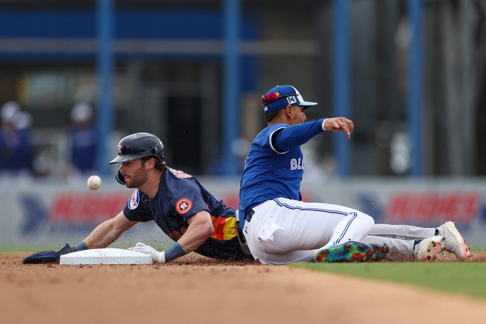 Mar 10, 2025; Dunedin, Florida, USA; Houston Astros outfielder Jacob Melton (76) steals second base past Toronto Blue Jays second baseman Andres Gimenez (0) in the second inning during spring training at TD Ballpark.