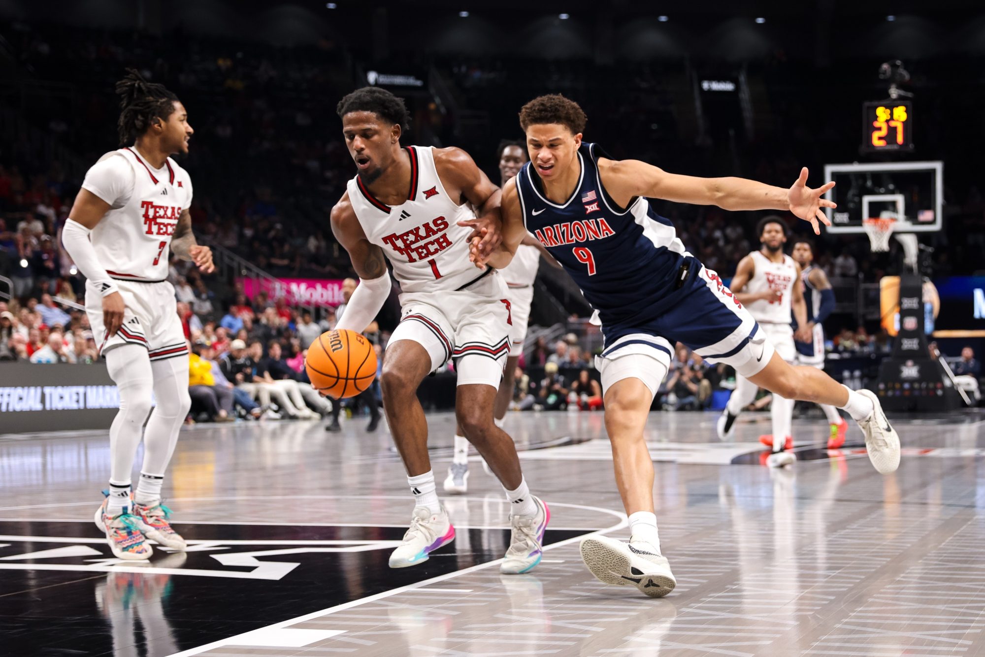 Mar 14, 2025; Kansas City, MO, USA; Texas Tech Red Raiders guard Kevin Overton (1) and Arizona Wildcats forward Carter Bryant (9) go after a loose ball during the second half at T-Mobile Center.