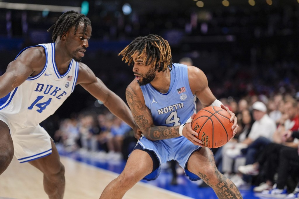 Mar 14, 2025; Charlotte, NC, USA; North Carolina Tar Heels guard RJ Davis (4) handles the ball against Duke Blue Devils guard Sion James (14) during the first half at Spectrum Center.