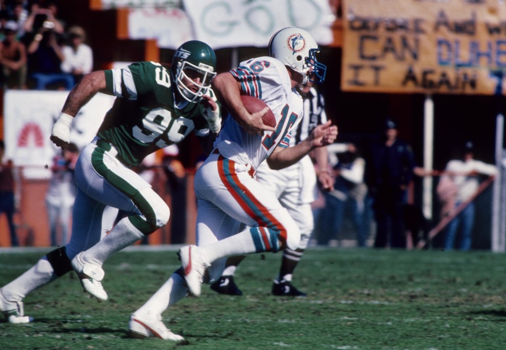 Dec. 18, 1982; New York, NY, USA; FILE PHOTO; Miami Dolphins quarterback David Woodley (16) is pursued by New York Jets defensive end Mark Gastineau (99) at the Orange Bowl.