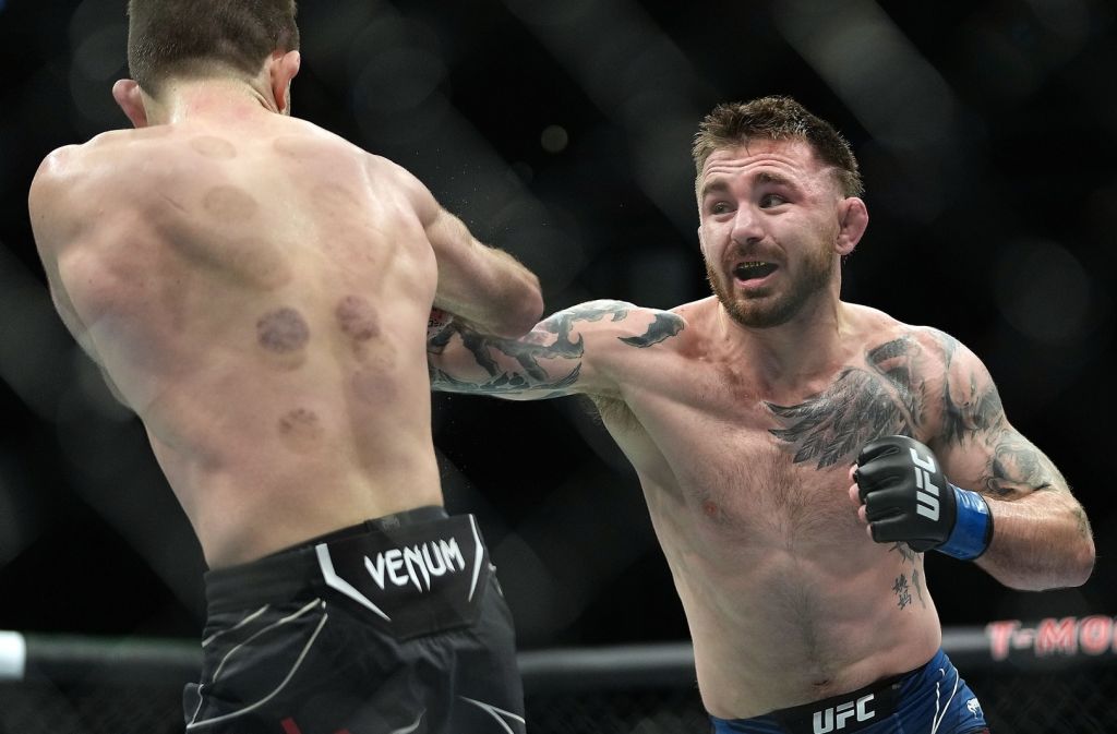 Dec 11, 2021; Las Vegas, Nevada, USA; Darrick Minner moves in with a hit against Ryan Hall during UFC 269 at T-Mobile Arena