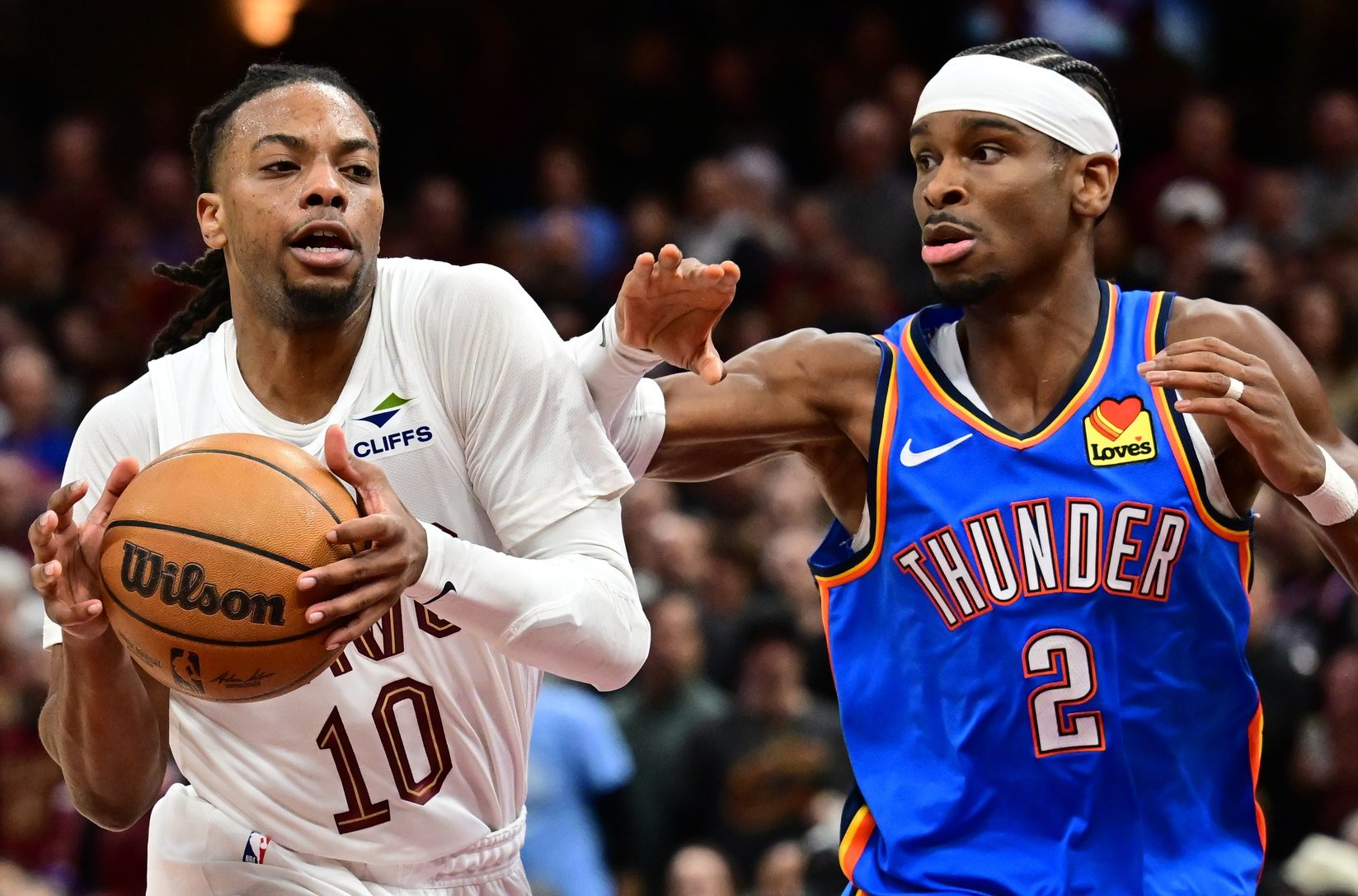 Jan 8, 2025; Cleveland, Ohio, USA; Cleveland Cavaliers guard Darius Garland (10) drives to the basket against Oklahoma City Thunder guard Shai Gilgeous-Alexander (2) during the second half at Rocket Mortgage FieldHouse.