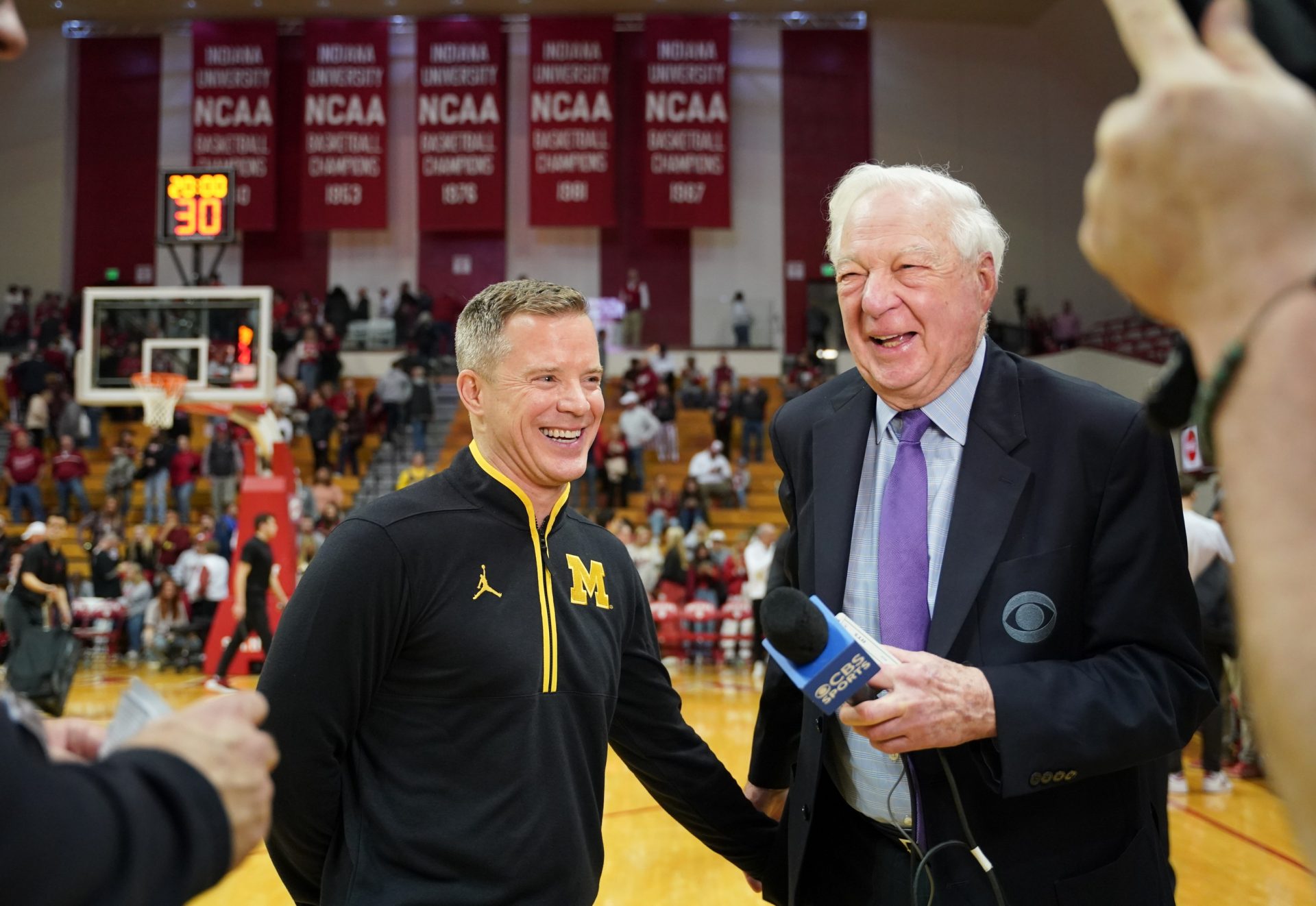 Feb 8, 2025; Bloomington, Indiana, USA; Michigan Wolverines head coach Dusty May talks to CBS broadcaster Bill Raftery after the game Indiana Hoosiers at Simon Skjodt Assembly Hall.