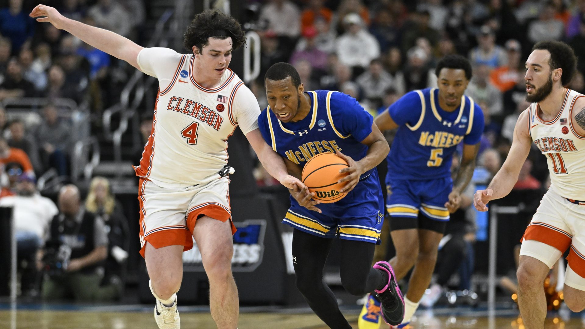 Mar 20, 2025; Providence, RI, USA; McNeese State Cowboys guard Quadir Copeland (11) brings the ball up court against Clemson Tigers forward Ian Schieffelin (4) during the second half at Amica Mutual Pavilion.