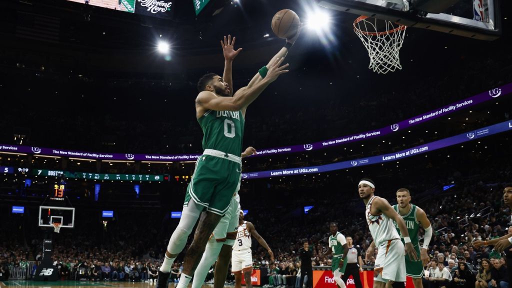 Apr 4, 2025; Boston, Massachusetts, USA; Boston Celtics forward Jayson Tatum (0) goes to the basket against the Phoenix Suns during the first quarter at TD Garden.