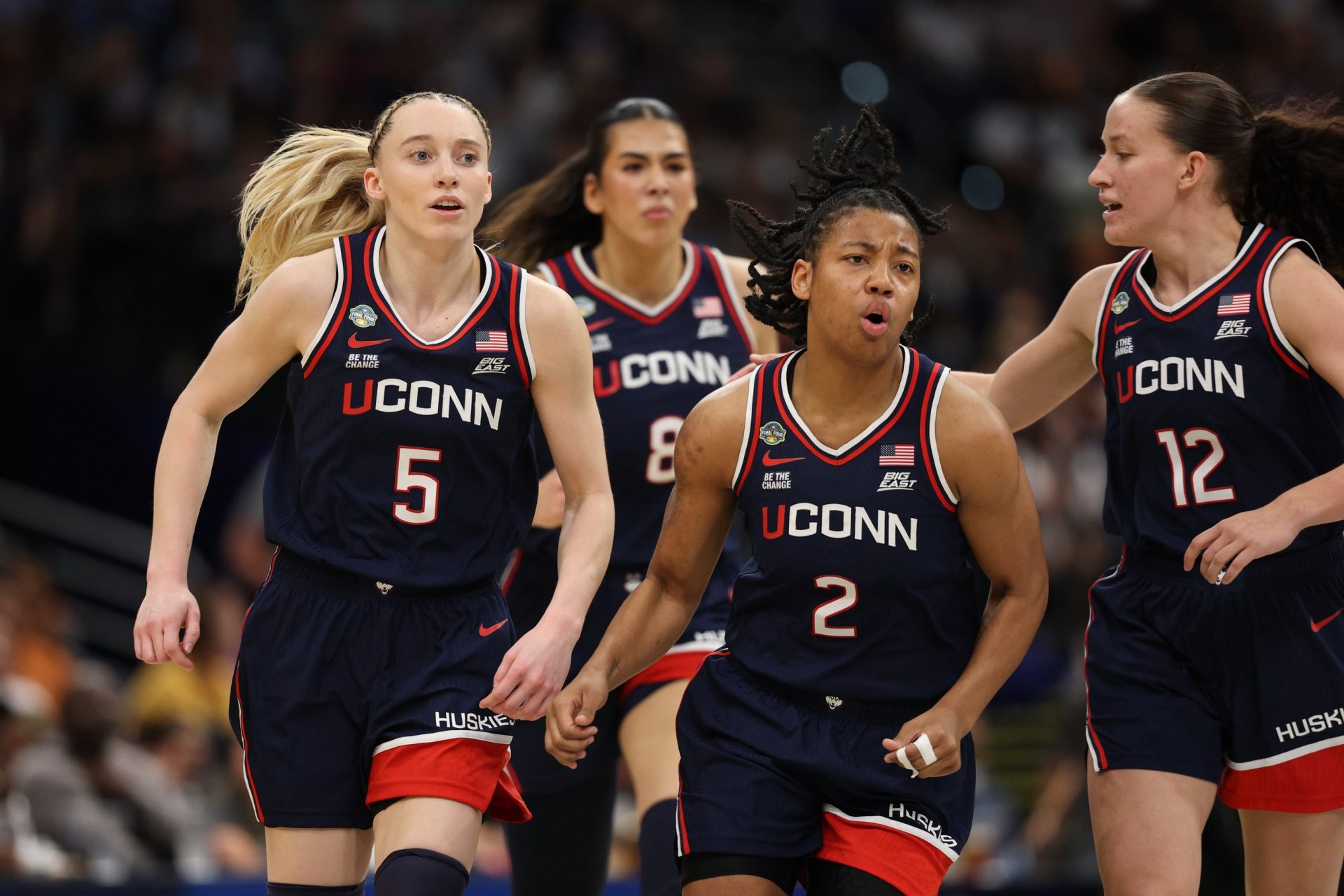 Apr 4, 2025; Tampa, FL, USA; Connecticut Huskies guard Paige Bueckers (5) and guard KK Arnold (2) react during first quarter in a semifinal of the women's 2025 NCAA tournament against the UCLA Bruins at Amalie Arena.