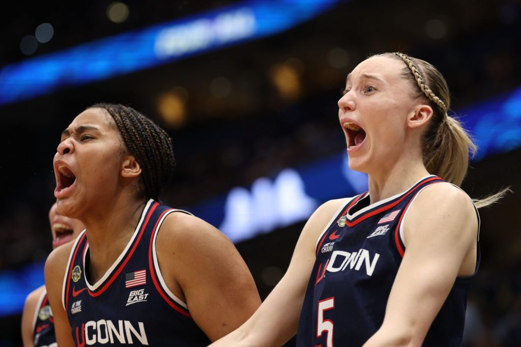 Apr 4, 2025; Tampa, FL, USA; Connecticut Huskies guard Paige Bueckers (5) and forward Sarah Strong (21) react on the bench during the fourth quarter in a semifinal of the women's 2025 NCAA tournament against the UCLA Bruins at Amalie Arena.