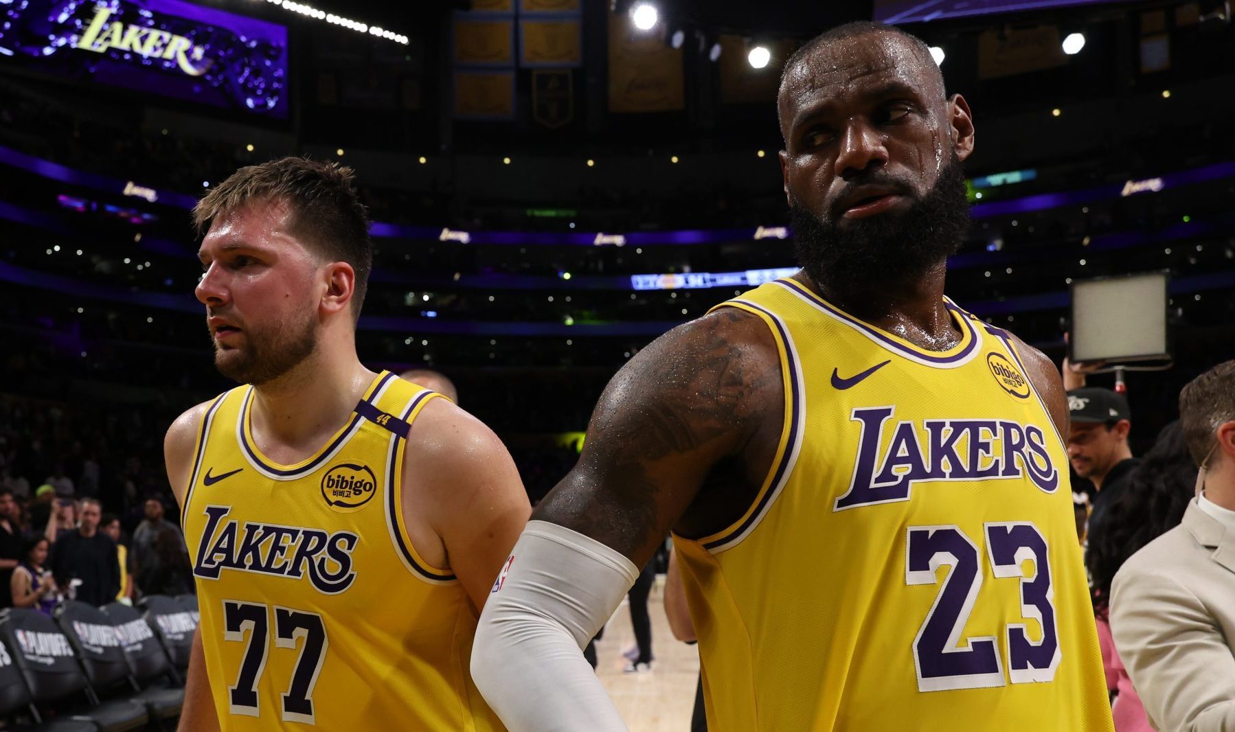 Apr 22, 2025; Los Angeles, California, USA; Los Angeles Lakers guard Luka Doncic (77) and Los Angeles Lakers forward LeBron James (23) leave a court after defeating the Minnesota Timberwolves 94-85 in game two of first round for the 2024 NBA Playoffs at Crypto.com Arena.