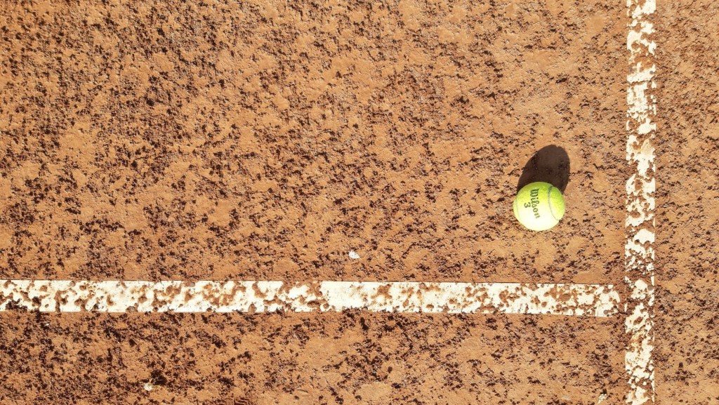 tennis ball on clay court