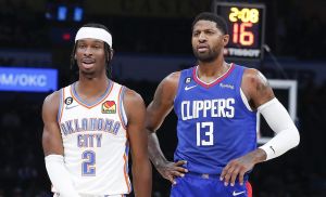 Oct 27, 2022; Oklahoma City, Oklahoma, USA; Oklahoma City Thunder guard Shai Gilgeous-Alexander (2) and LA Clippers guard Paul George (13) walks down the court during a time out during the first half at Paycom Center.