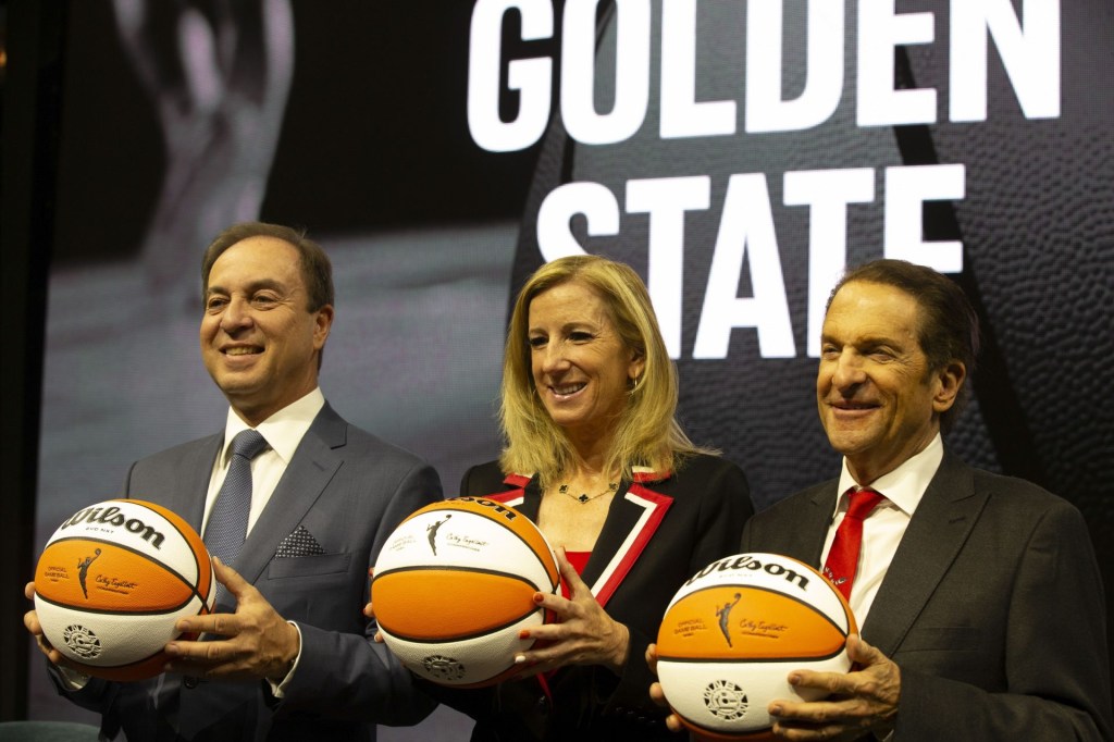 Oct 5, 2023; San Francisco, CA, USA; Golden State Warriors co-executive director & chief executive officer Joe Lacob, WNBA commissioner Cathy Engelbert and Warriors co-executive director Peter Guber pose for a group photo during a press conference to announce an expansion WNBA franchise in the San Francisco Bay Area at Chase Center.
