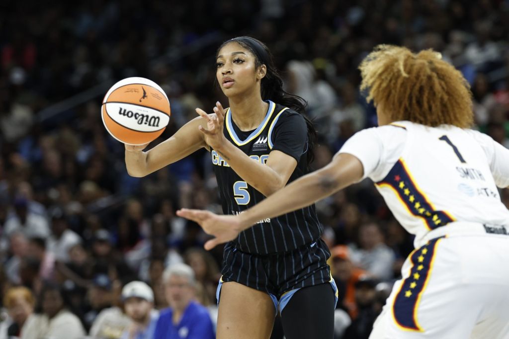 Jun 23, 2024; Chicago, Illinois, USA; Chicago Sky forward Angel Reese (5) passes the ball against Indiana Fever forward NaLyssa Smith (1) during the second half of a basketball game at Wintrust Arena.