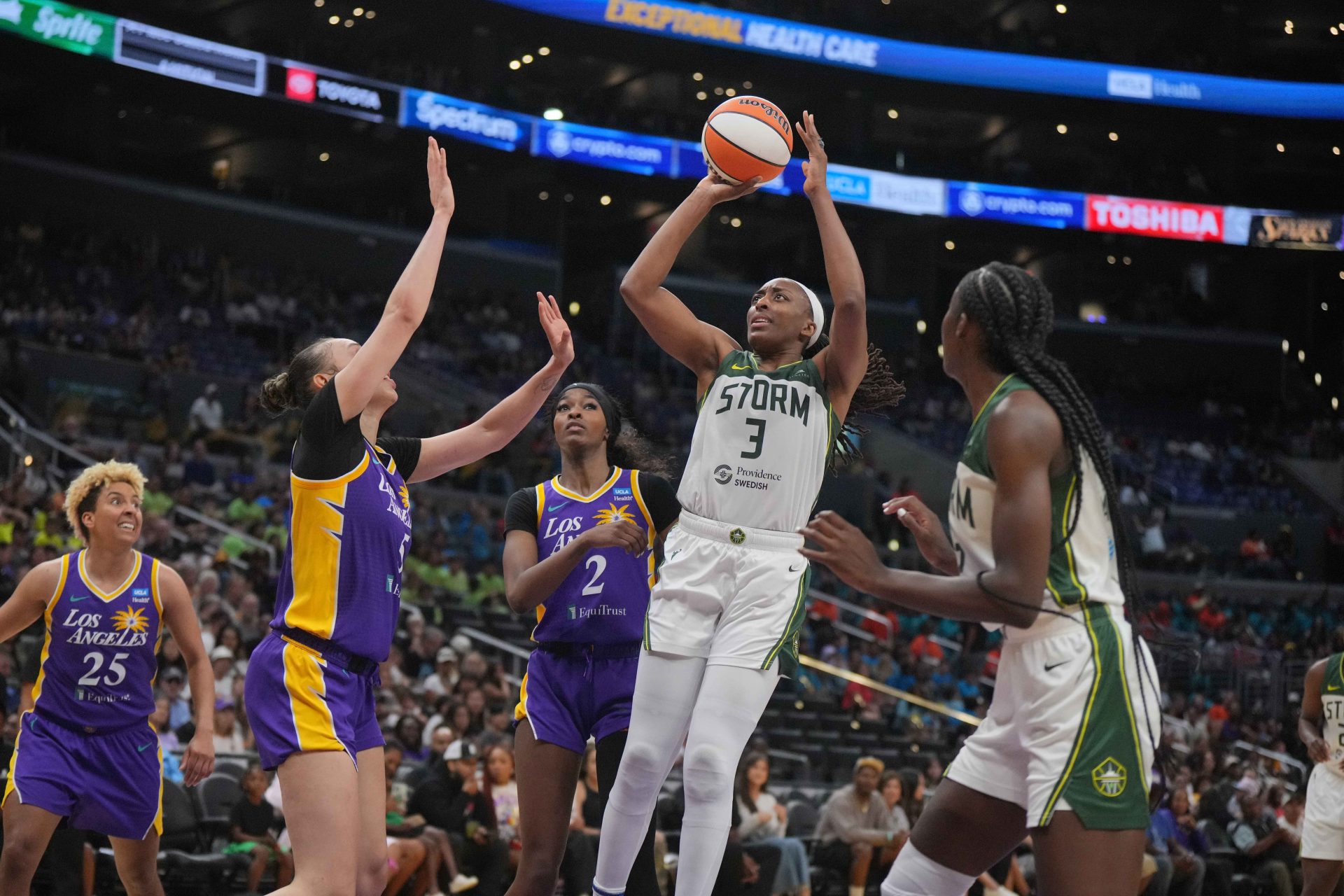 Jul 16, 2024; Los Angeles, California, USA; Seattle Storm forward Nneka Ogwumike (3) shoots the ball against LA Sparks forward Dearica Hamby (5) and LA Sparks forward Rickea Jackson (2) in the second half at Crypto.com Arena.