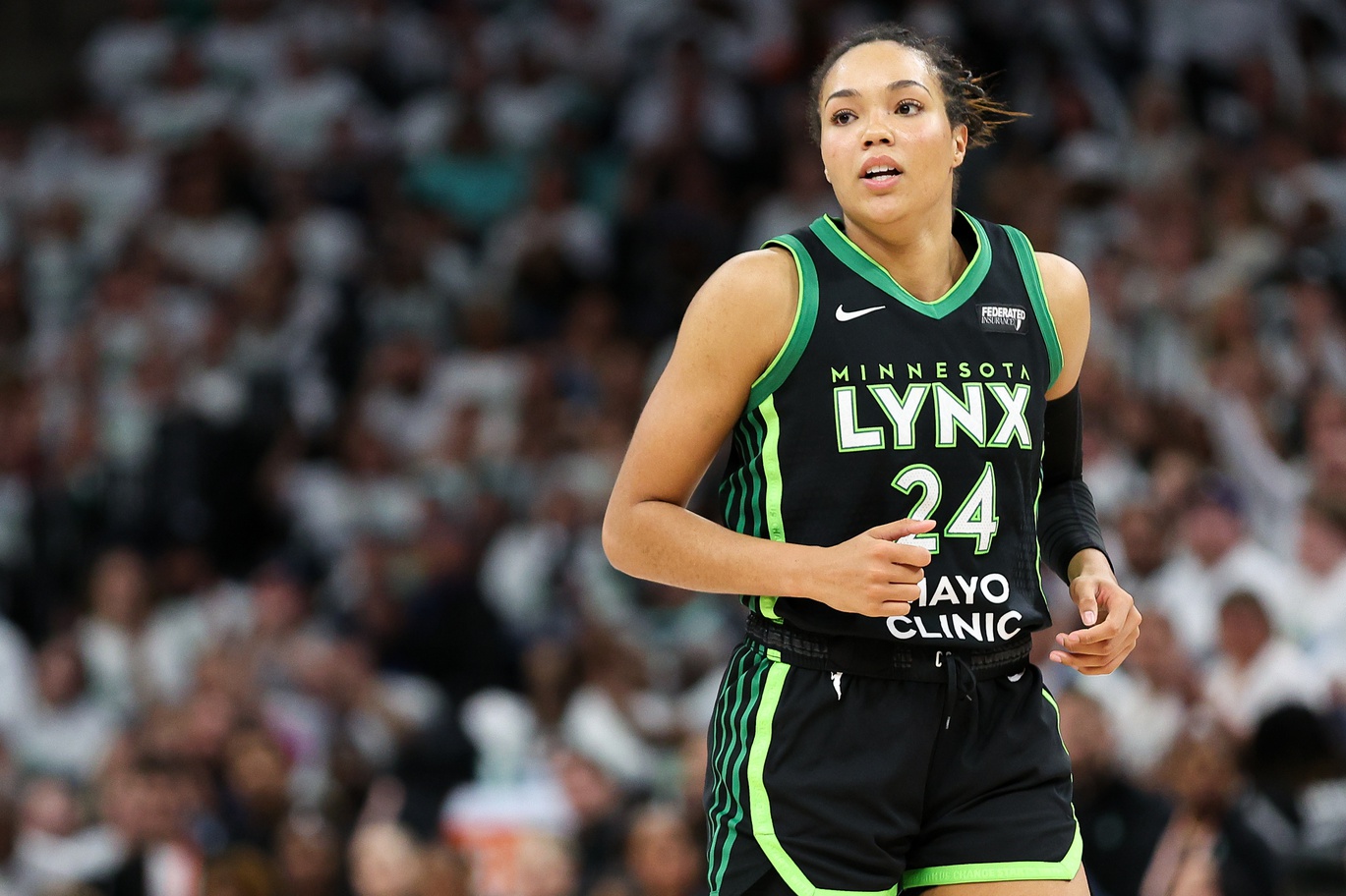 Oct 16, 2024; Minneapolis, Minnesota, USA; Minnesota Lynx forward Napheesa Collier (24) reacts to her basket against the New York Liberty during the first half of game three of the 2024 WNBA Finals at Target Center.
