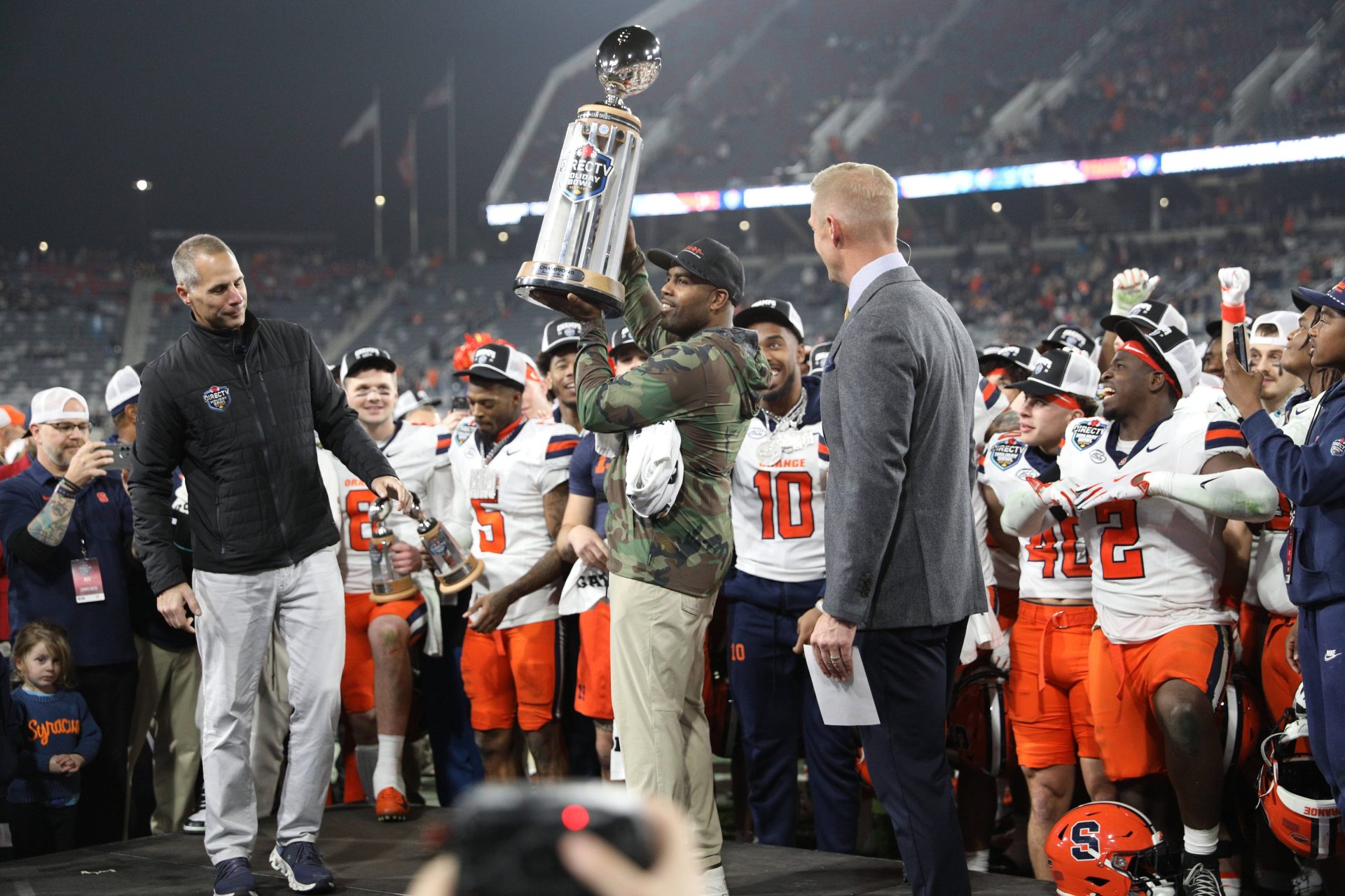 Dec 27, 2024; San Diego, CA, USA; Syracuse Orange head coach Fran Brown raises the Holiday Bowl trophy after defeating the Washington State Cougars after the game at Snapdragon Stadium.