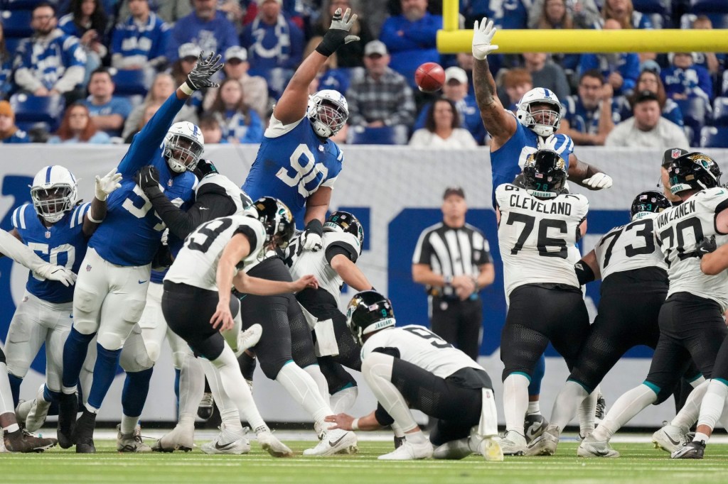 Indianapolis Colts defense leap in an attempt to block an extra point kick by Jacksonville Jaguars place kicker Cam Little (39) on Sunday, Jan. 5, 2025, during a game against the Jacksonville Jaguars at Lucas Oil Stadium in Indianapolis.