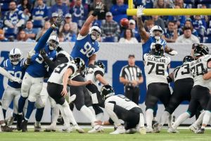 Indianapolis Colts defense leap in an attempt to block an extra point kick by Jacksonville Jaguars place kicker Cam Little (39) on Sunday, Jan. 5, 2025, during a game against the Jacksonville Jaguars at Lucas Oil Stadium in Indianapolis.