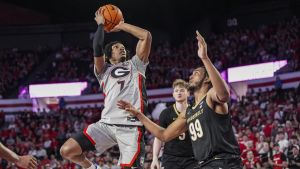 Mar 8, 2025; Athens, Georgia, USA; Georgia Bulldogs guard Tyrin Lawrence (7) shoots over Vanderbilt Commodores forward Devin McGlockton (99) during the first half at Stegeman Coliseum.