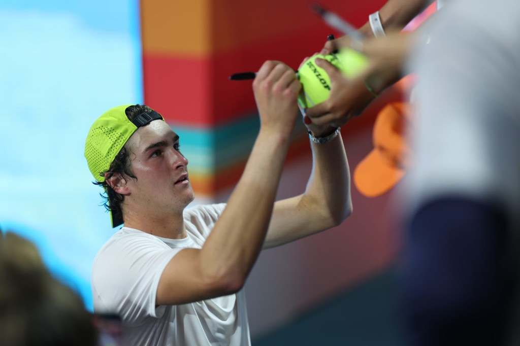 Mar 20, 2025; Miami, FL, USA; Joao Fonseca (BRA) signs autographs after his match against Learner Tien (USA)(not pictured) on day three of the Miami Open at Hard Rock Stadium.