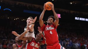 Mar 28, 2025; Atlanta, GA, USA; Mississippi Rebels forward Jaemyn Brakefield (4) rebounds over Michigan State Spartans center Carson Cooper (15) and Mississippi Rebels guard Matthew Murrell (11) in the second half of a South Regional semifinal of the 2025 NCAA tournament at State Farm Arena.