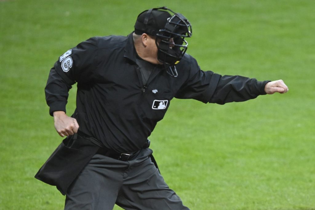 Apr 12, 2025; Cleveland, Ohio, USA; MLB umpire Ron Kulpa (46) calls a third strike during a game between the Cleveland Guardians and the Kansas City Royals at Progressive Field