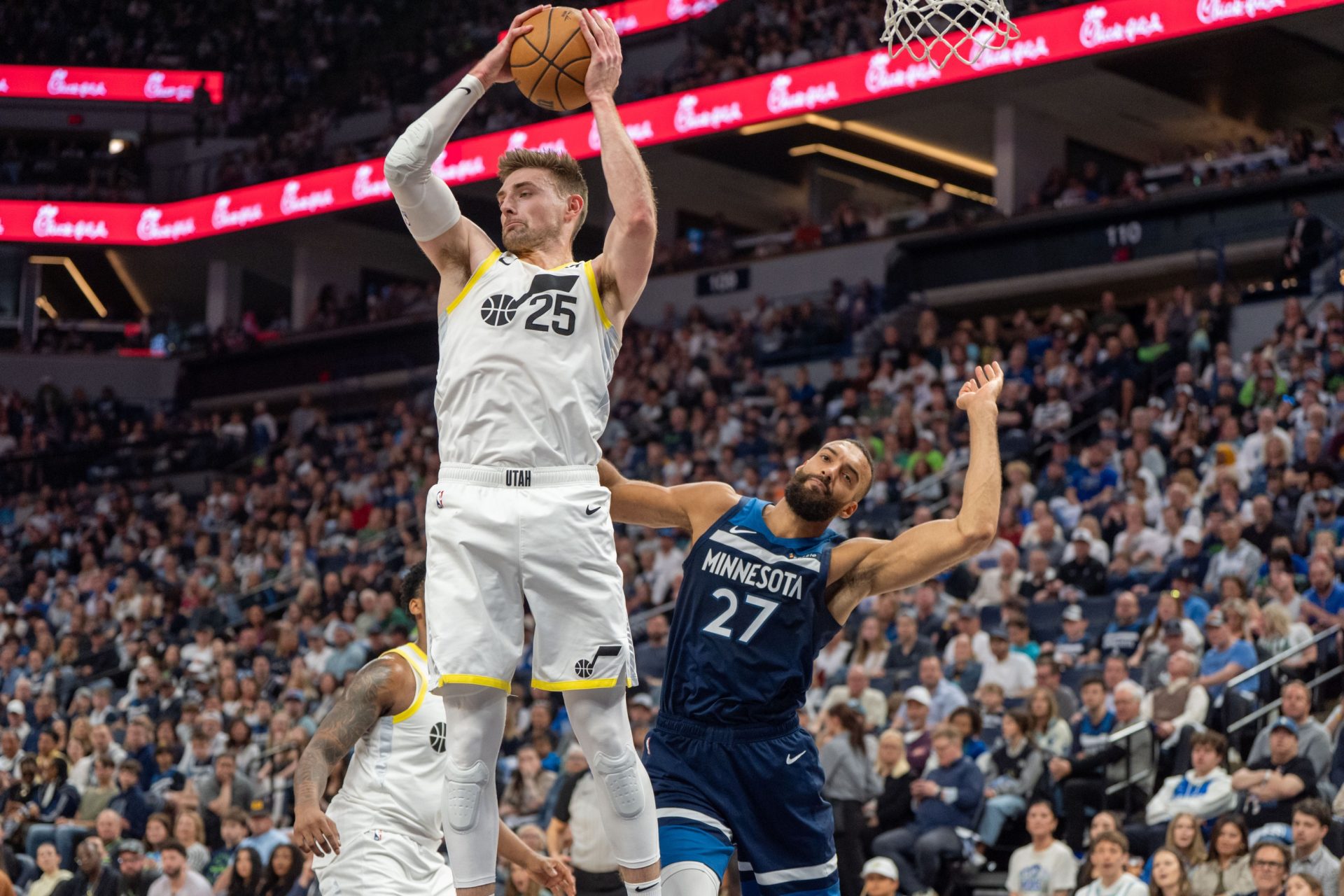 Apr 13, 2025; Minneapolis, Minnesota, USA; Utah Jazz center Micah Potter (25) rebounds the ball over Minnesota Timberwolves center Rudy Gobert (27) in the second quarter at Target Center.