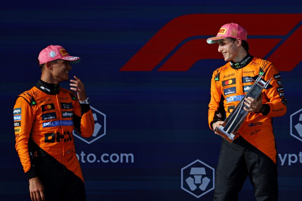 May 4, 2025; Miami Gardens, FL, USA; McLaren driver Oscar Piastri (right) celebrates with the winners trophy while talking McLaren driver Lando Norris (left) after winning the F1 Miami Grand Prix at Miami International Autodrome.
