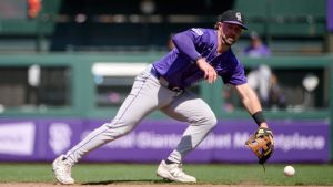 May 4, 2025; San Francisco, California, USA; Colorado Rockies second baseman Kyle Farmer (6) fields a ground ball against the San Francisco Giants during the eighth inning at Oracle Park.