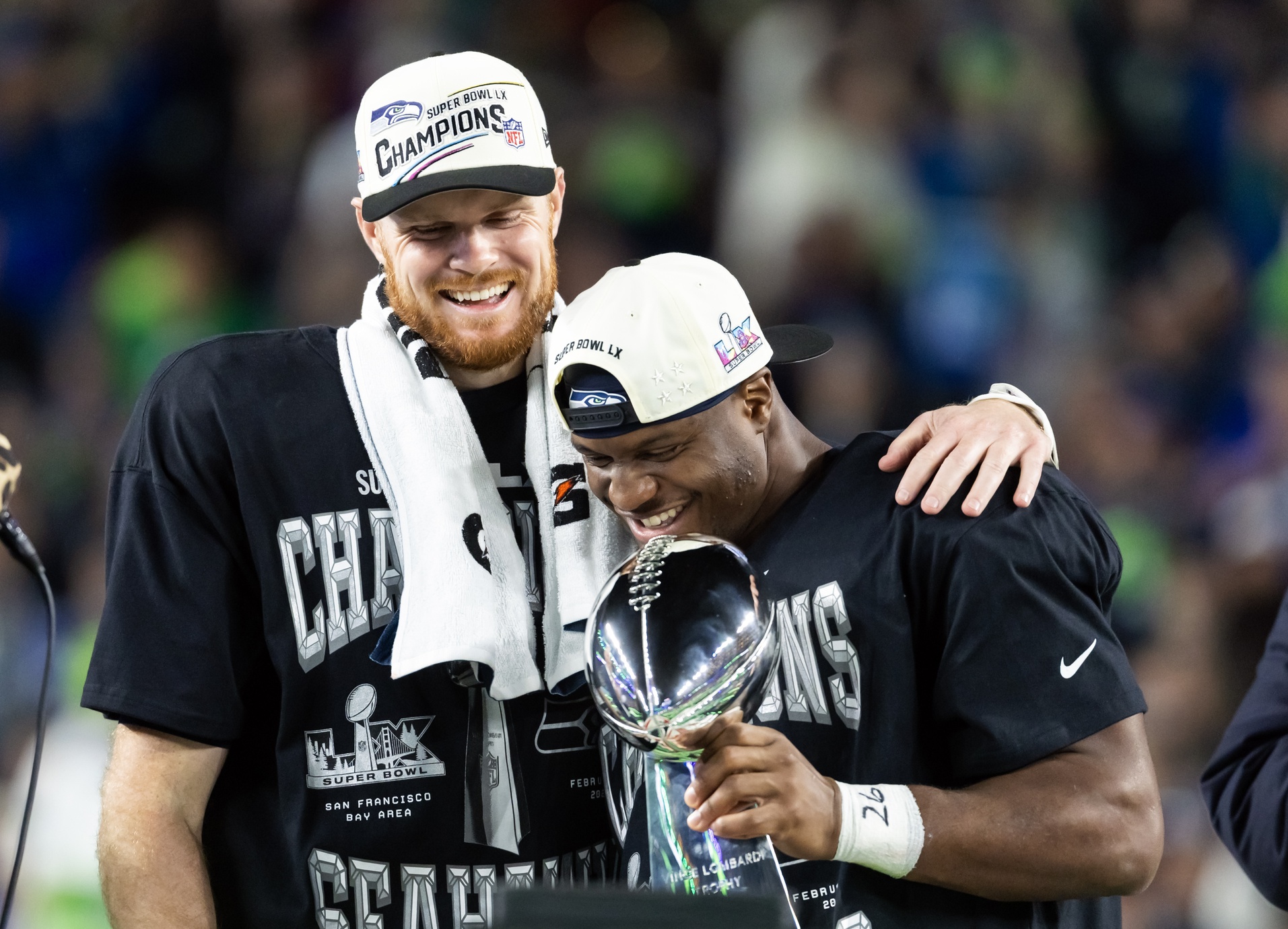 Feb 8, 2026; Santa Clara, CA, USA; Seattle Seahawks quarterback Sam Darnold (14) and running back Kenneth Walker III (9) celebrate with the Vince Lombardi trophy after defeating the New England Patriots in Super Bowl LX at Levi's Stadium.