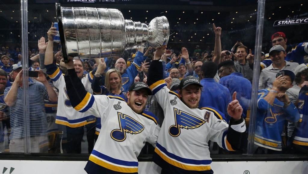 Jun 12, 2019; Boston, MA, USA; St. Louis Blues center Ivan Barbashev (49) and right wing Vladimir Tarasenko (91) hoists the Stanley Cup after defeating the Boston Bruins in game seven of the 2019 Stanley Cup Final at TD Garden