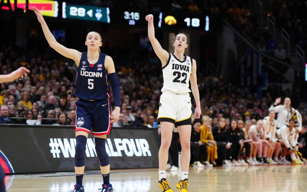 Apr 5, 2024; Cleveland, OH, USA; Iowa Hawkeyes guard Caitlin Clark (22) and Connecticut Huskies guard Paige Bueckers (5) react in the second quarter in the semifinals of the Final Four of the womens 2024 NCAA Tournament at Rocket Mortgage FieldHouse.