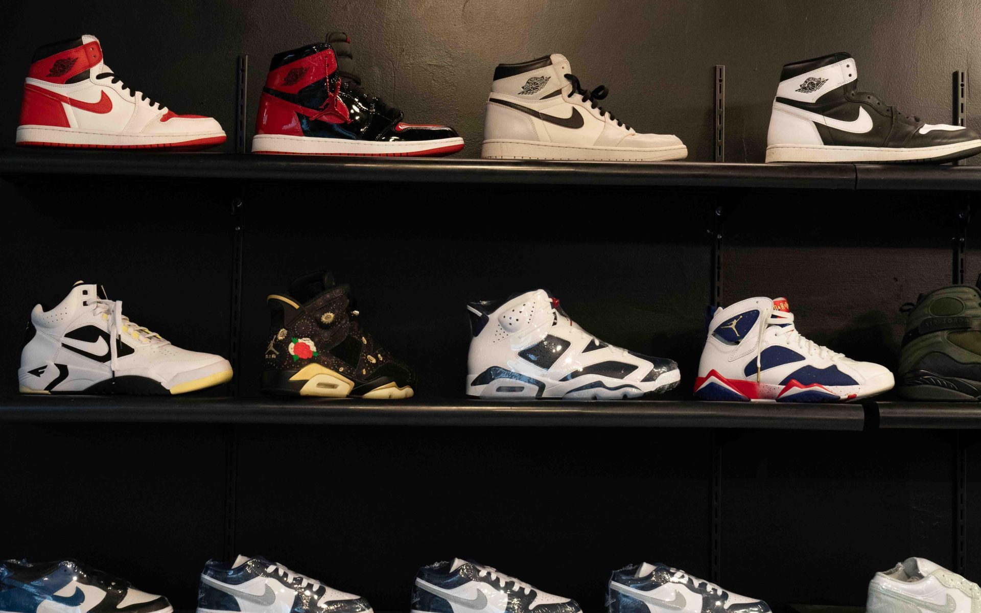 From vintage to unique collaborations, various Nike and Jordan shoes are displayed on a wall at Saved Soles inside West Ridge Mall.