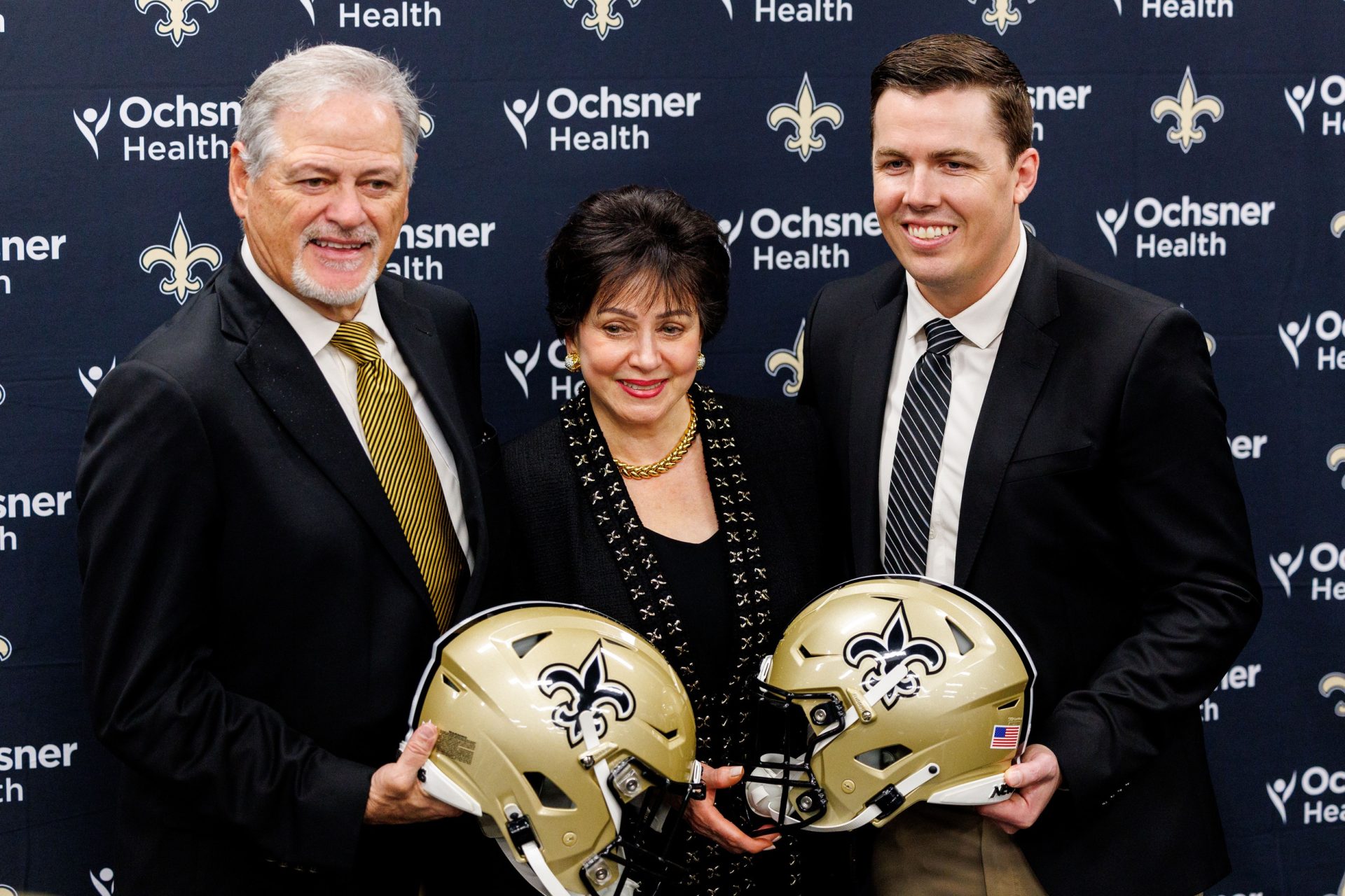Feb 13, 2025; New Orleans, LA, USA; New Orleans Saints owner Gayle Benson and general manager Mickey Loomis pose with the new head coach Kellen Moore at Ochsner Sports Performance Center.