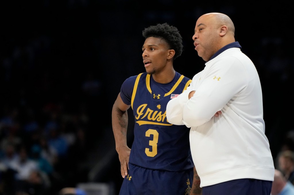 Mar 12, 2025; Charlotte, NC, USA; Notre Dame Fighting Irish guard Markus Burton (3) with head coach Micah Shrewsberry in the first half at Spectrum Center