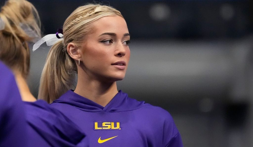 Mar 22, 2025; Birmingham AL, USA; LSU gymnast Livvy Dunne stretches with teammates before Session 2 of the SEC Gymnastics Tournament at Legacy Arena in Birmingham, Alabama.